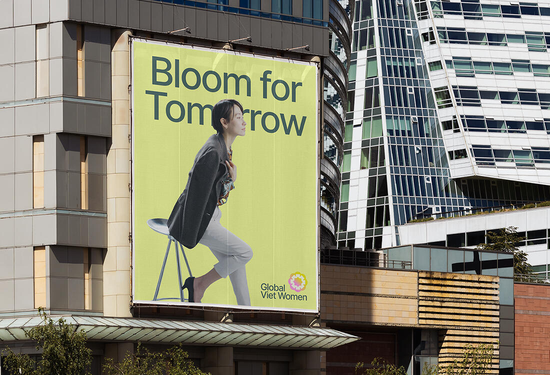 Cover Image for "Global Viet Women" Cover image for the project "Global Viet Women". The image consists of a large billboard in a city. The billboard is a simple poster advertising for the organization. It features a confident Vietnamese women leaning on her chair. She is wearing professiona